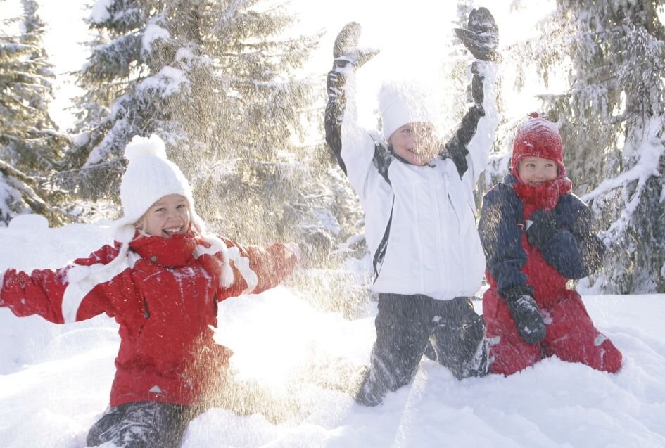 Three children playing in the snow
